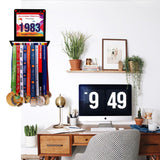 Victory Hangers® Race Bib Holder + Medal Display Rack V1 installed in a home office, showcasing medals and race bibs as decor and motivation.