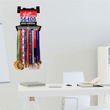 Race Bib Holder + Medal Hanger Display Rack V2 mounted on wall in modern home office, showcasing medals and race bibs in stylish display.