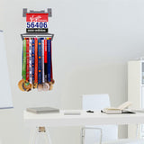 Race Bib Holder + Medal Hanger Display Rack V2 mounted on a wall in a modern office space, displaying race medals and bibs in an organized fashion.